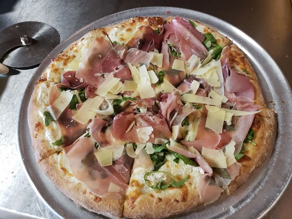 Pizza with Prosciutto Arugula and Parmesan